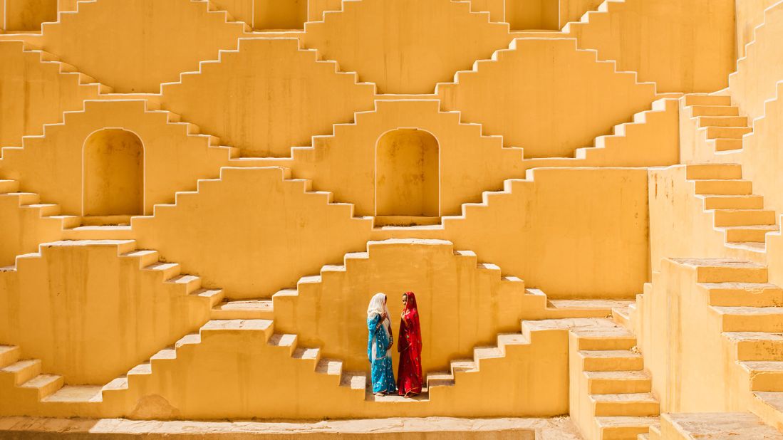 Manisha and Jasmin Singh pause in the Baoli, an ancient step well in a village near the city of Jaipur outside of India's Thar desert. The image was captured by Ami Vitale.