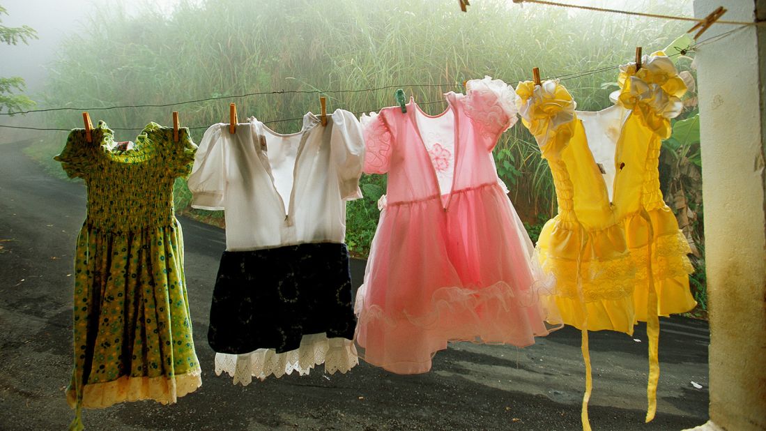 Small dresses hang on a laundry line on a porch in Utuado, Puerto Rico. Taken by Amy Toensing in August 2002.