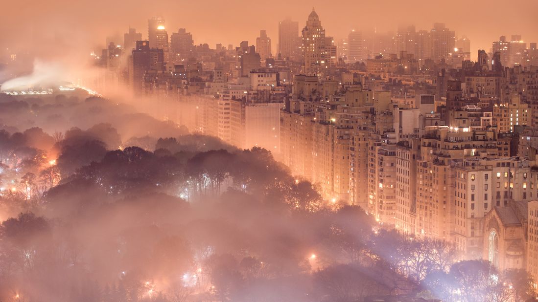 This image shows low flying clouds and fog looming over Central Park in New York City. Captured by Jim Richardson.