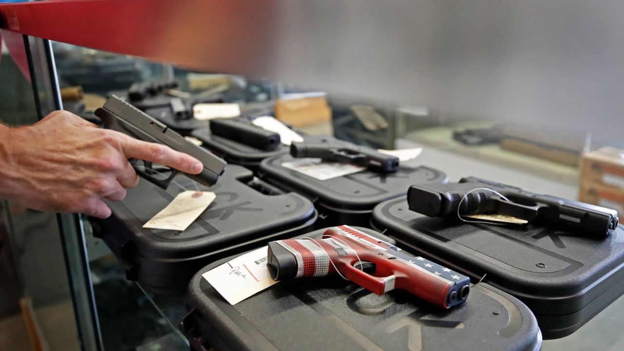 A worker restocks handguns at Davidson Defense in Orem, Utah on March 20, 2020. 