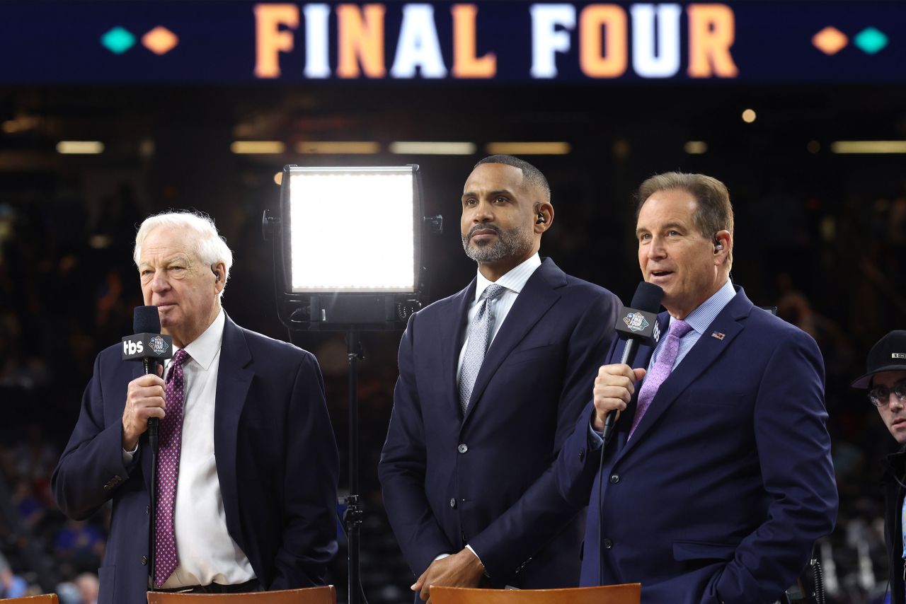 From left, TV announcers Bill Raftery, Grant Hill and Jim Nantz stand on the sidelines.