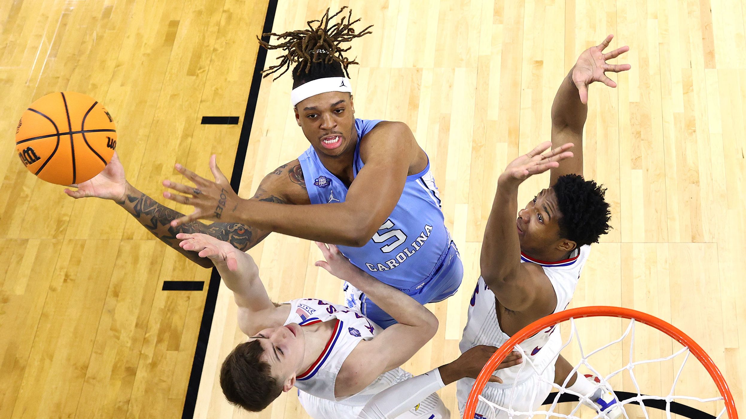 Bacot tries to shoot over Braun and McCormack in the first half. He finished the half with 12 points and 10 rebounds.