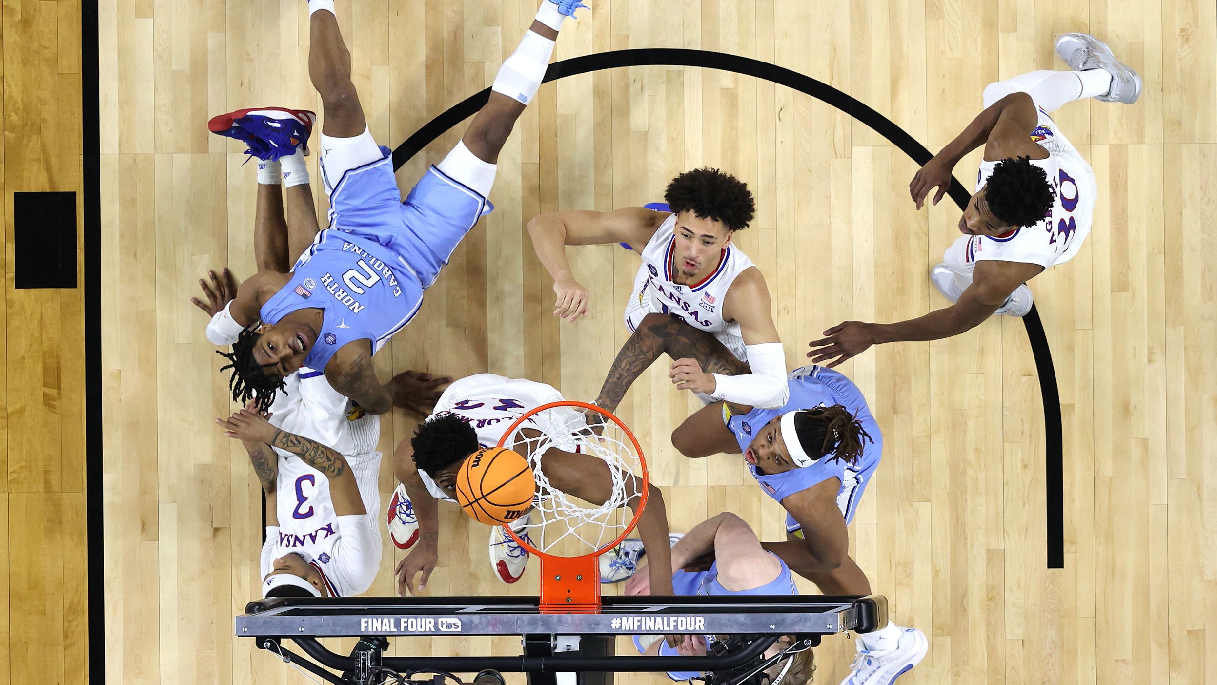 Players watch the ball for a possible rebound.