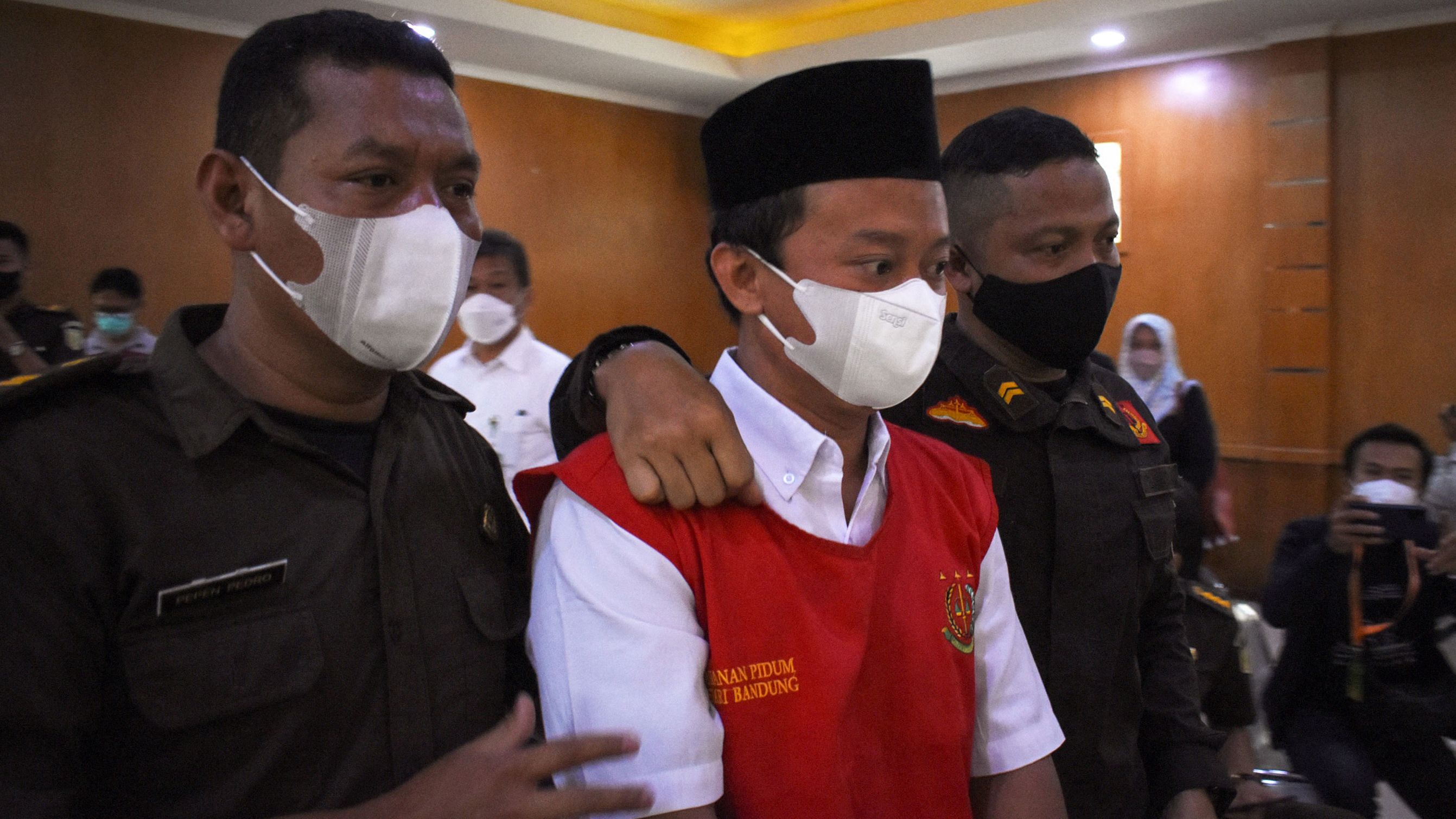 Teacher Herry Wirawan is escorted at a court in Bandung, West Java on February 15.