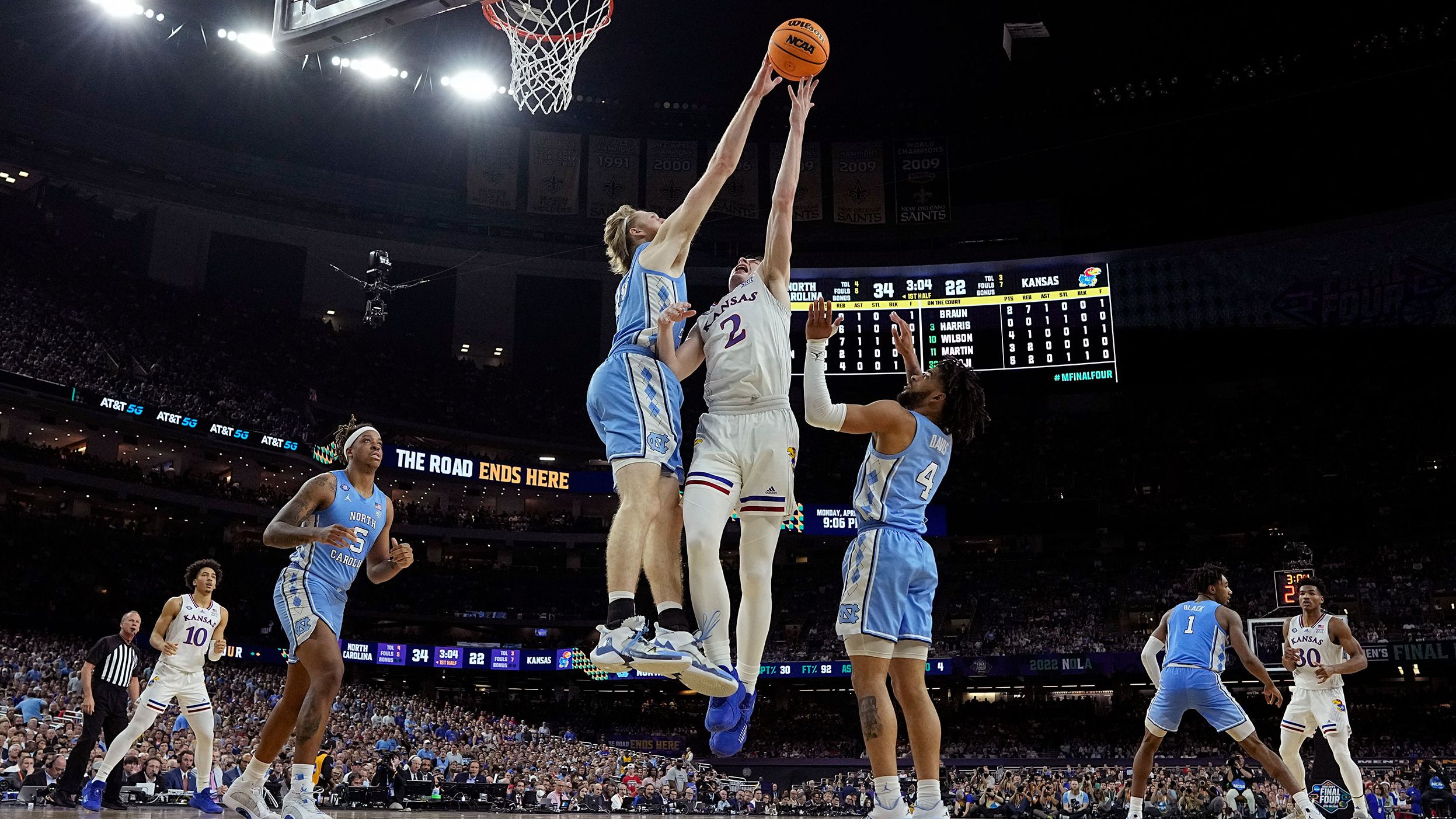 Manek blocks a shot by Kansas guard Christian Braun during the first half.