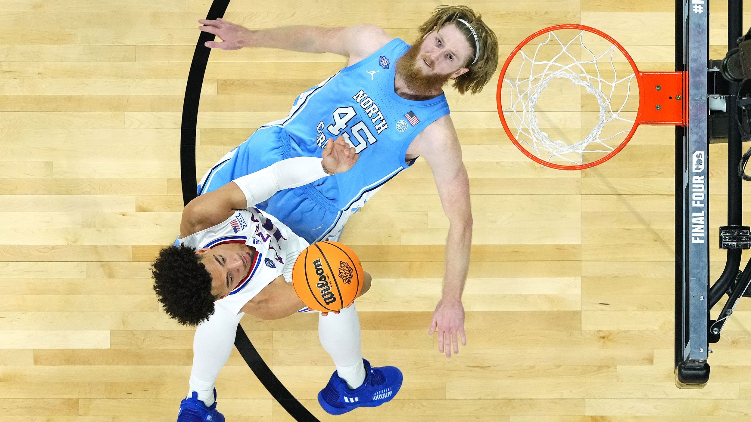 Manek tries to take a charge while Wilson drives to the basket. Manek, however, was called for a block.