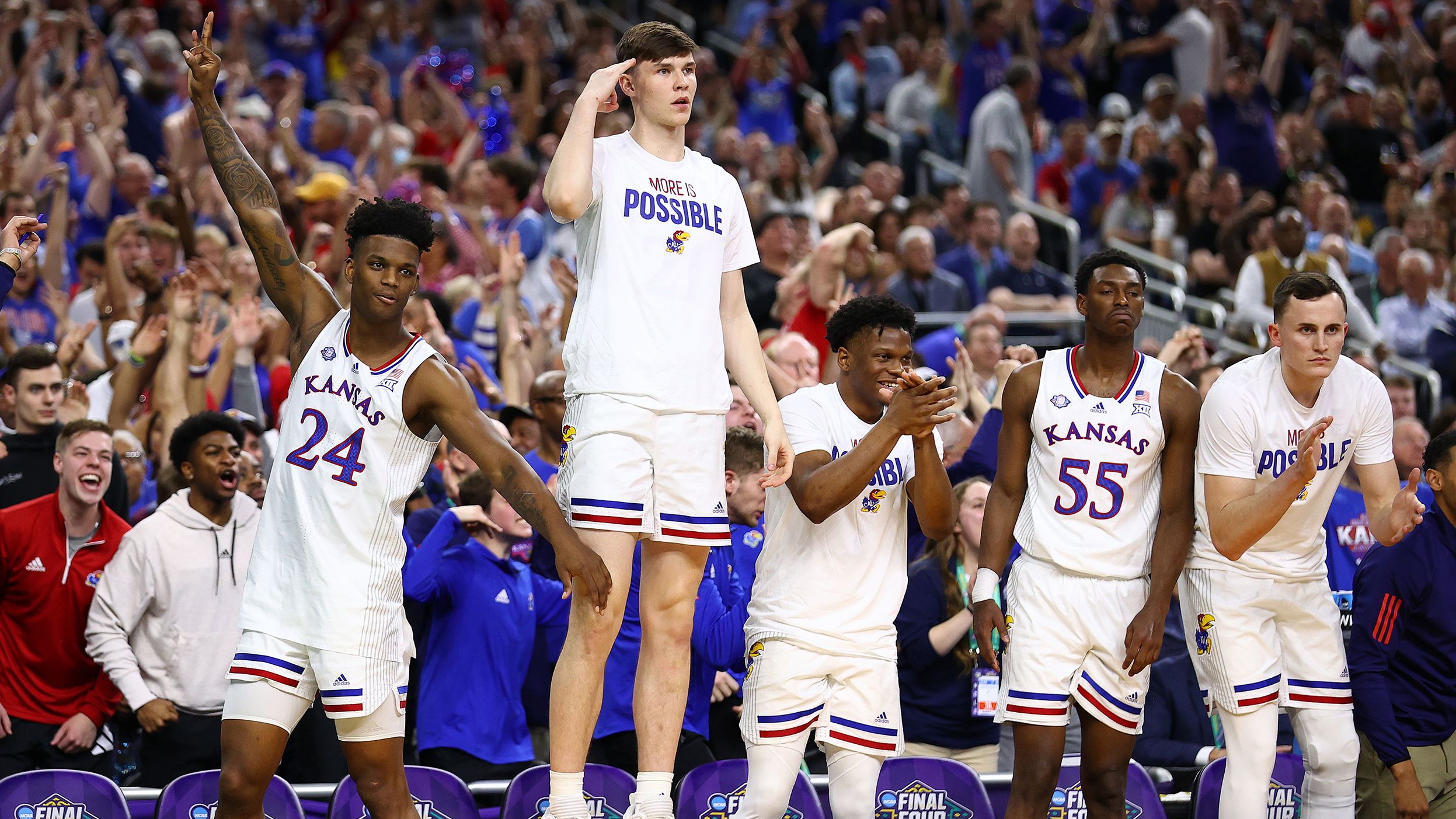 The Kansas bench reacts during the team's second-half comeback.