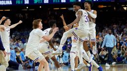 Kansas guard Ochai Agbaji celebrates with teammates after their win against North Carolina in a college basketball game in the finals of the Men's Final Four NCAA tournament, Monday, April 4, 2022, in New Orleans. (AP Photo/David J. Phillip)