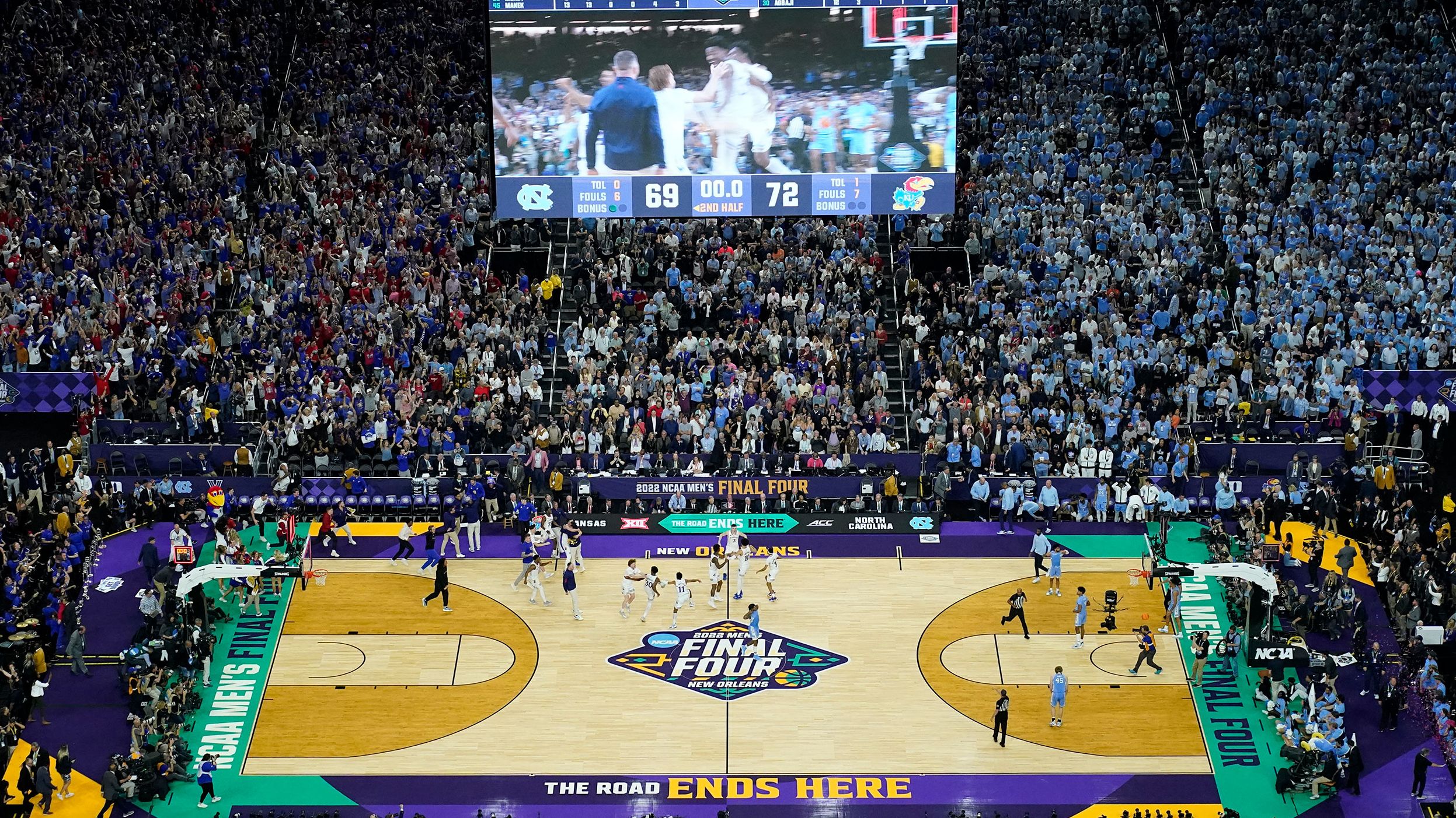 Kansas players rush the court after the final buzzer.