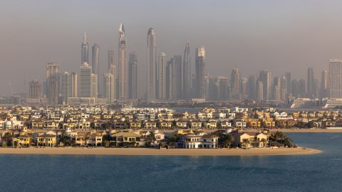 A view of the villas on the waterside of the Palm Jumeirah, backdropped by skyscrapers beyond, in Dubai, United Arab Emirates, in February 2022.