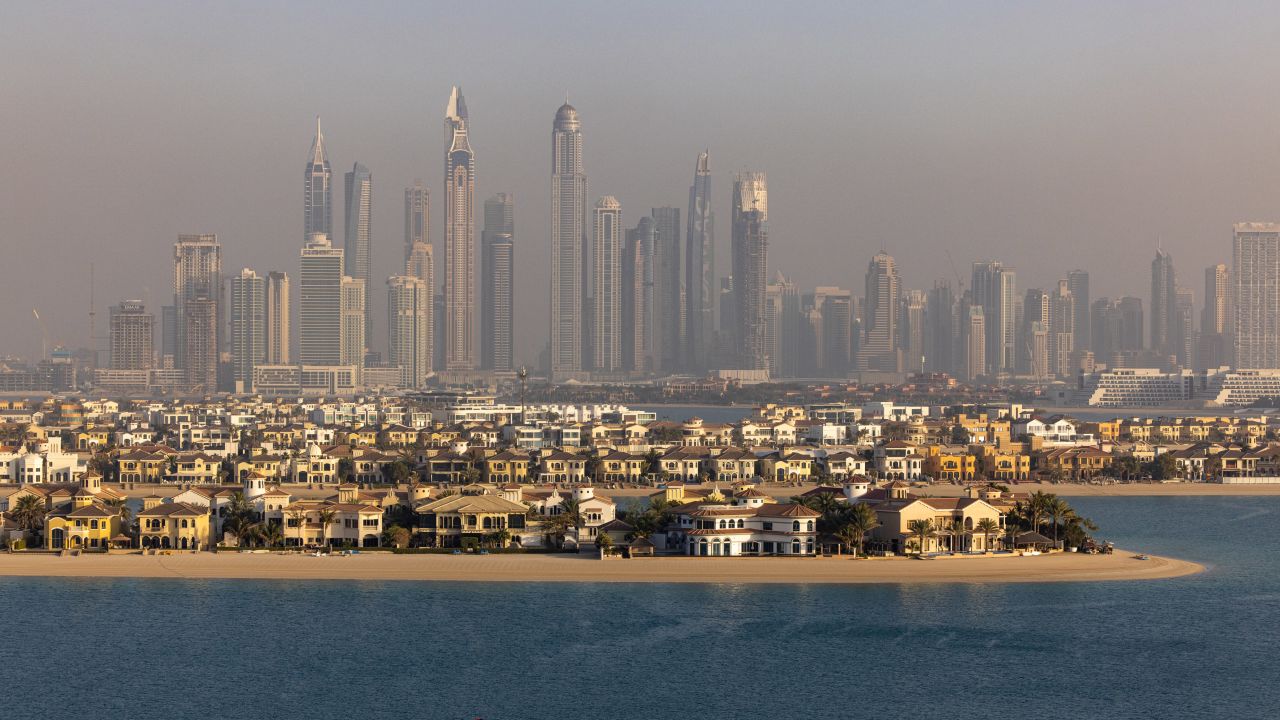 A view of the villas on the waterside of the Palm Jumeirah, backdropped by skyscrapers beyond, in Dubai, United Arab Emirates, in February 2022.