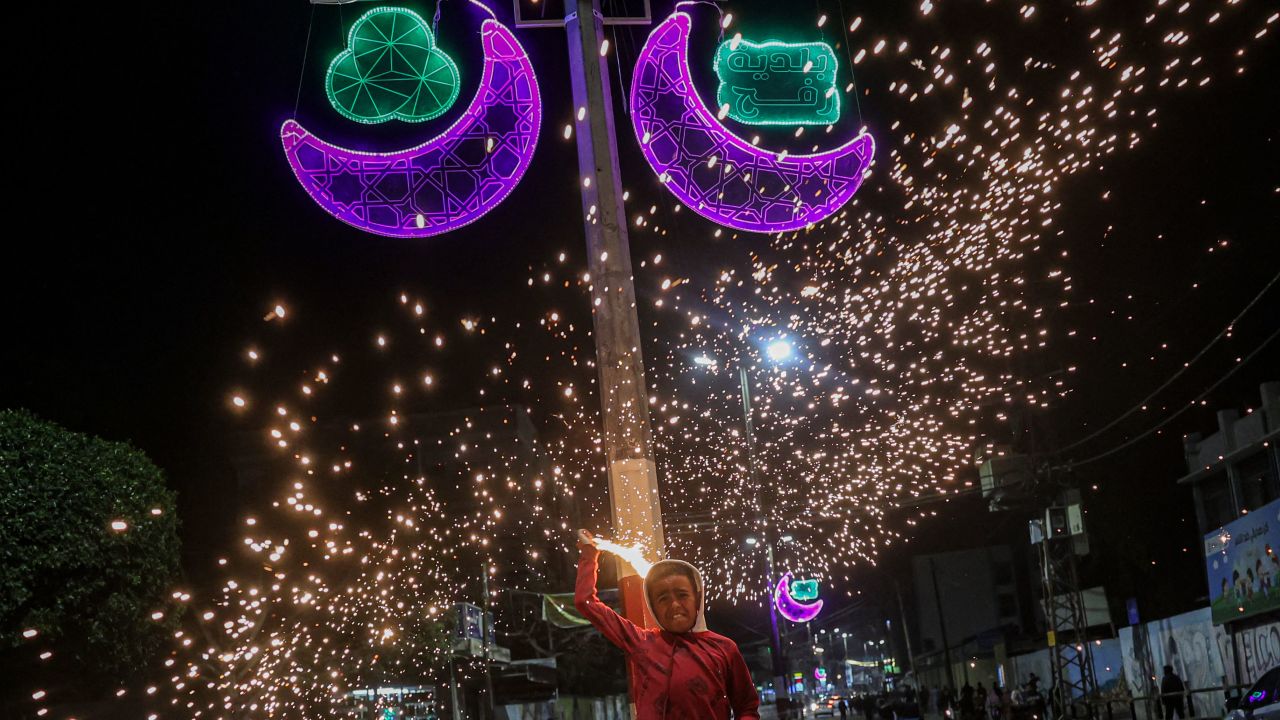 A Palestinian child waves fireworks on April 2, celebrating the start of the Muslim fasting month of Ramadan in the southern Gaza Strip town of Rafah.