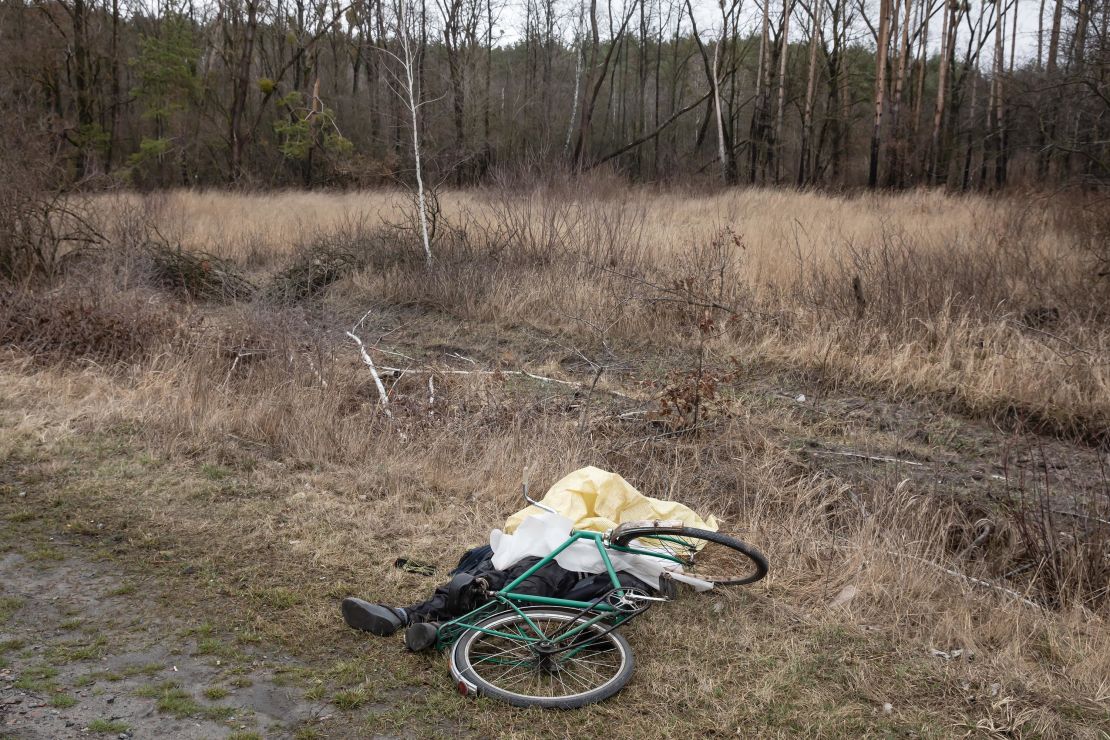 A dead civilian is seen next to his bicycle on a road near the forest in Bucha, Kyiv region. 