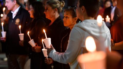 People attend a candlelight vigil for the victims of a fatal shooting held in Sacramento, California, on Monday, April 4, 2022.