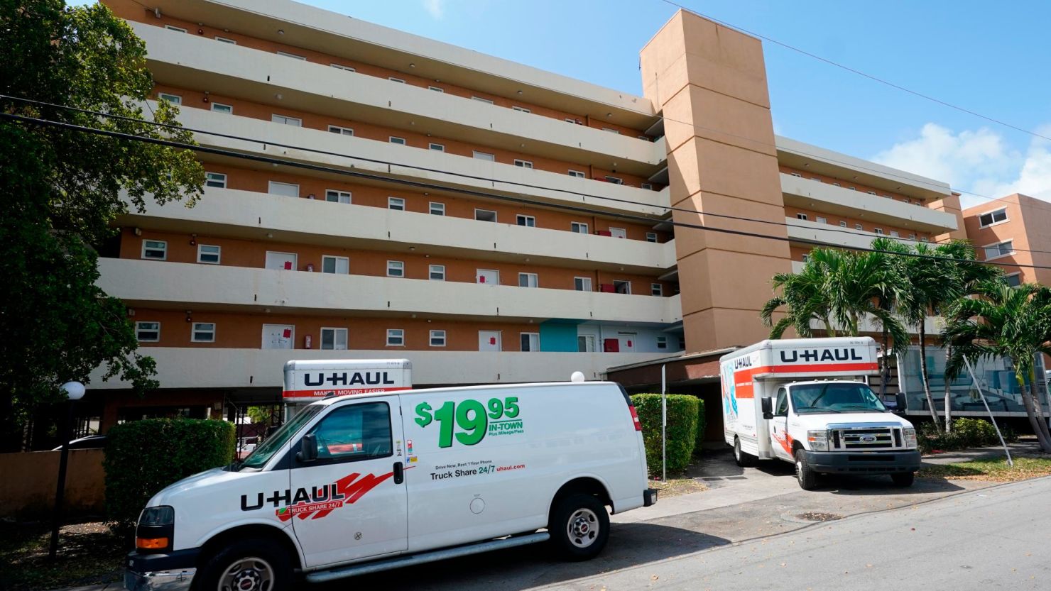 Moving vans and trucks are parked outside the Bayview 60 Homes apartment building in North Miami Beach, Florida, on Tuesday, April 5.