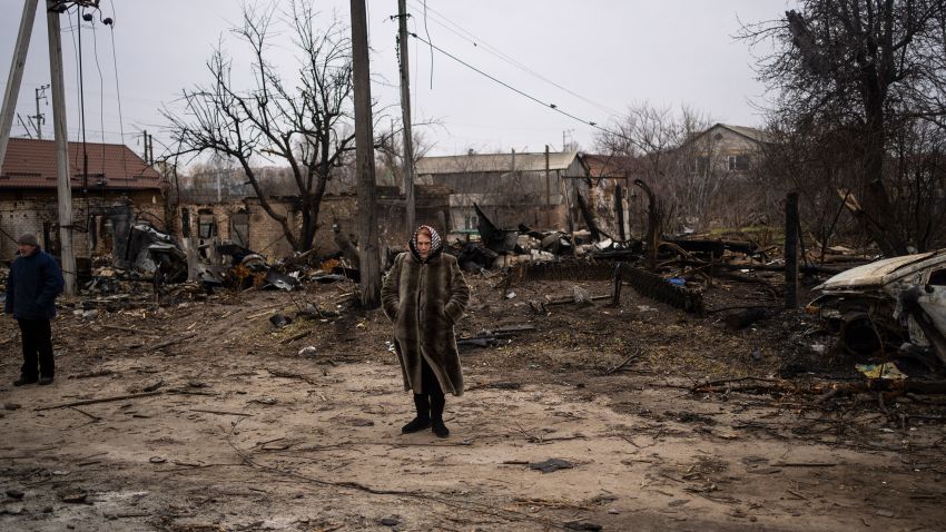 A woman stands amid the destruction caused by the war in Bucha, in the outskirts of Kyiv, Ukraine, Tuesday, April 5, 2022. Ukraine's president planned to address the U.N.'s most powerful body on Tuesday after even more grisly evidence emerged of civilian massacres in areas that Russian forces recently withdrew from. (AP Photo/Rodrigo Abd)