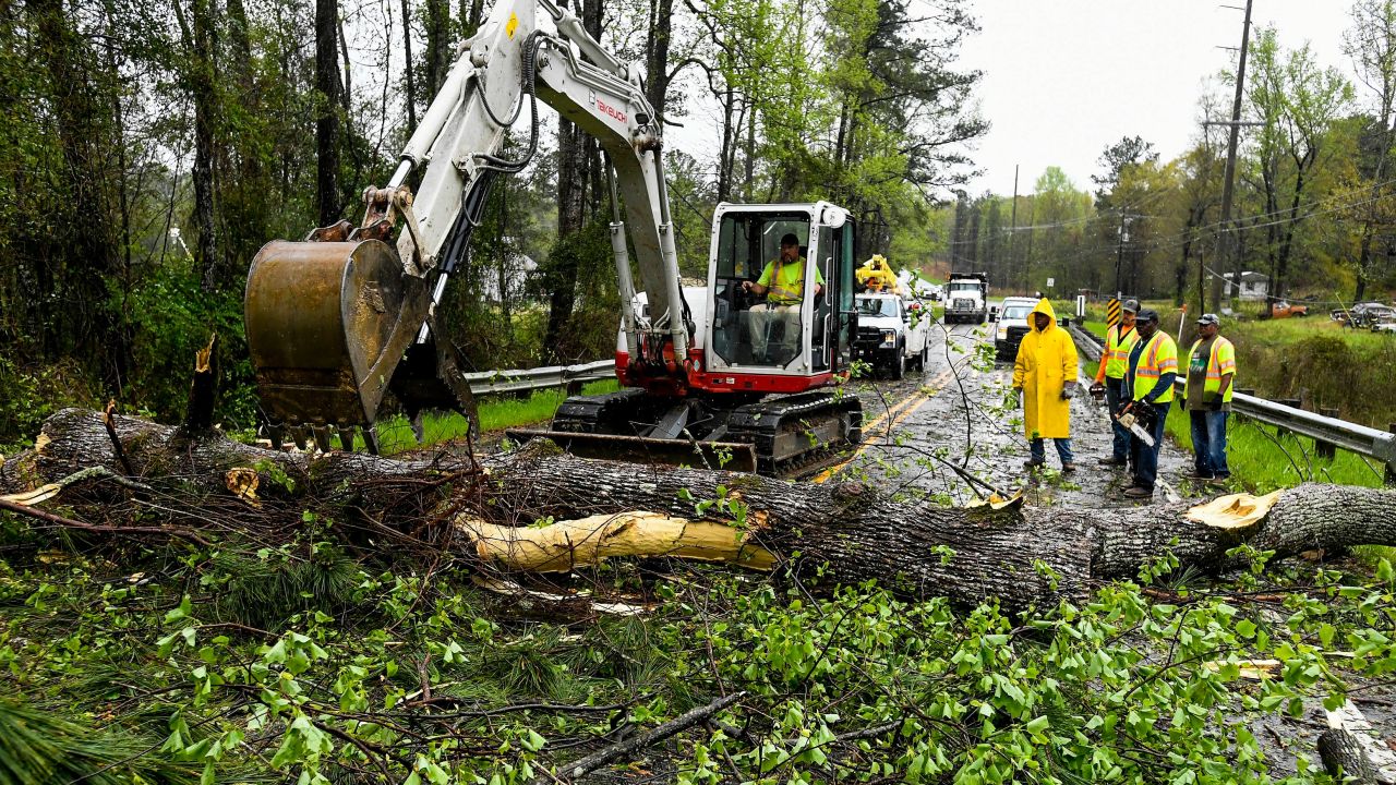 Workers clear downed trees after a storm hit  near the Alabama community of Wetumpka on Tuesday.