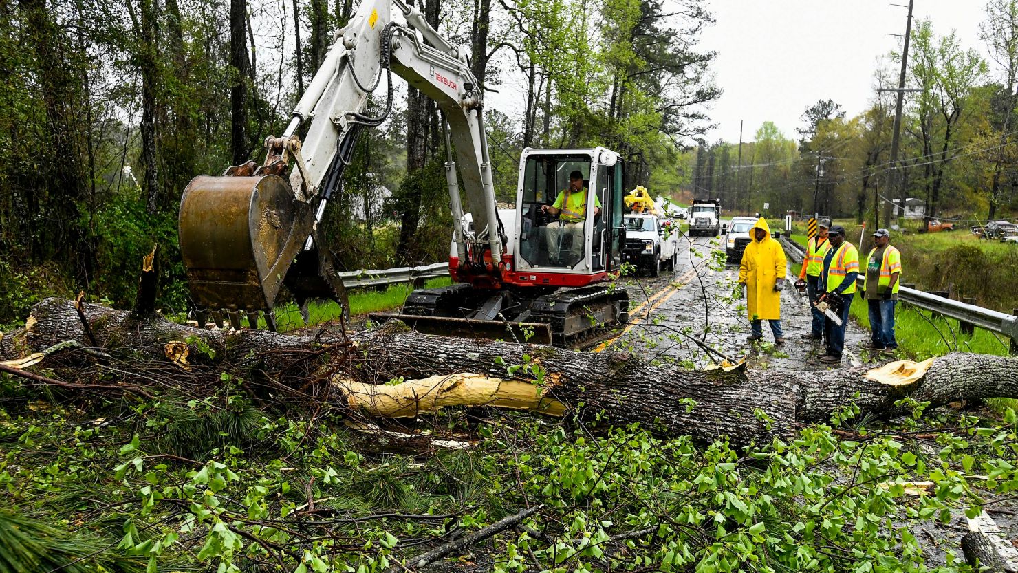 Workers clear downed trees after a storm hit  near the Alabama community of Wetumpka on Tuesday.