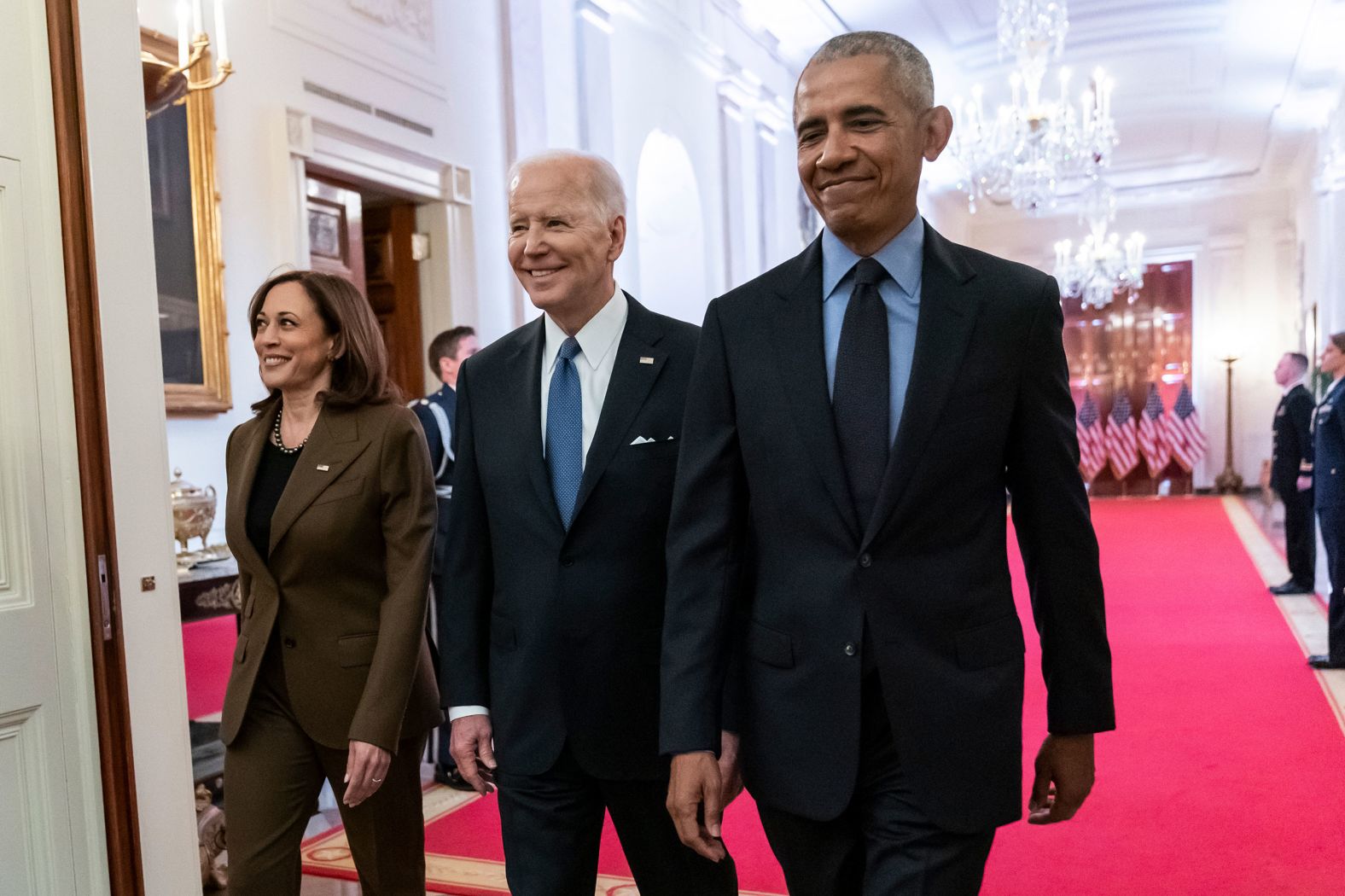 Harris, Biden and Obama walk to the event in  the East Room.