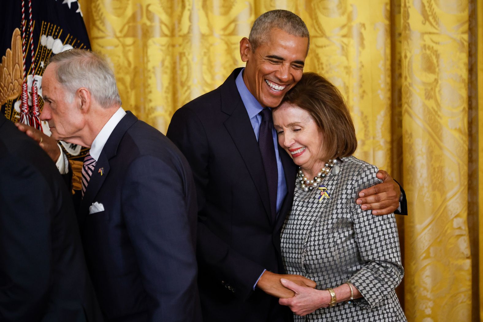 Obama hugs House Speaker Nancy Pelosi at the end of the event Monday.