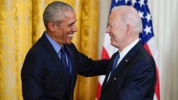 Former President Barack Obama shakes hands with President Joe Biden after Biden spoke about the Affordable Care Act, in the East Room of the White House in Washington, Tuesday, April 5, 2022. (AP Photo/Carolyn Kaster)