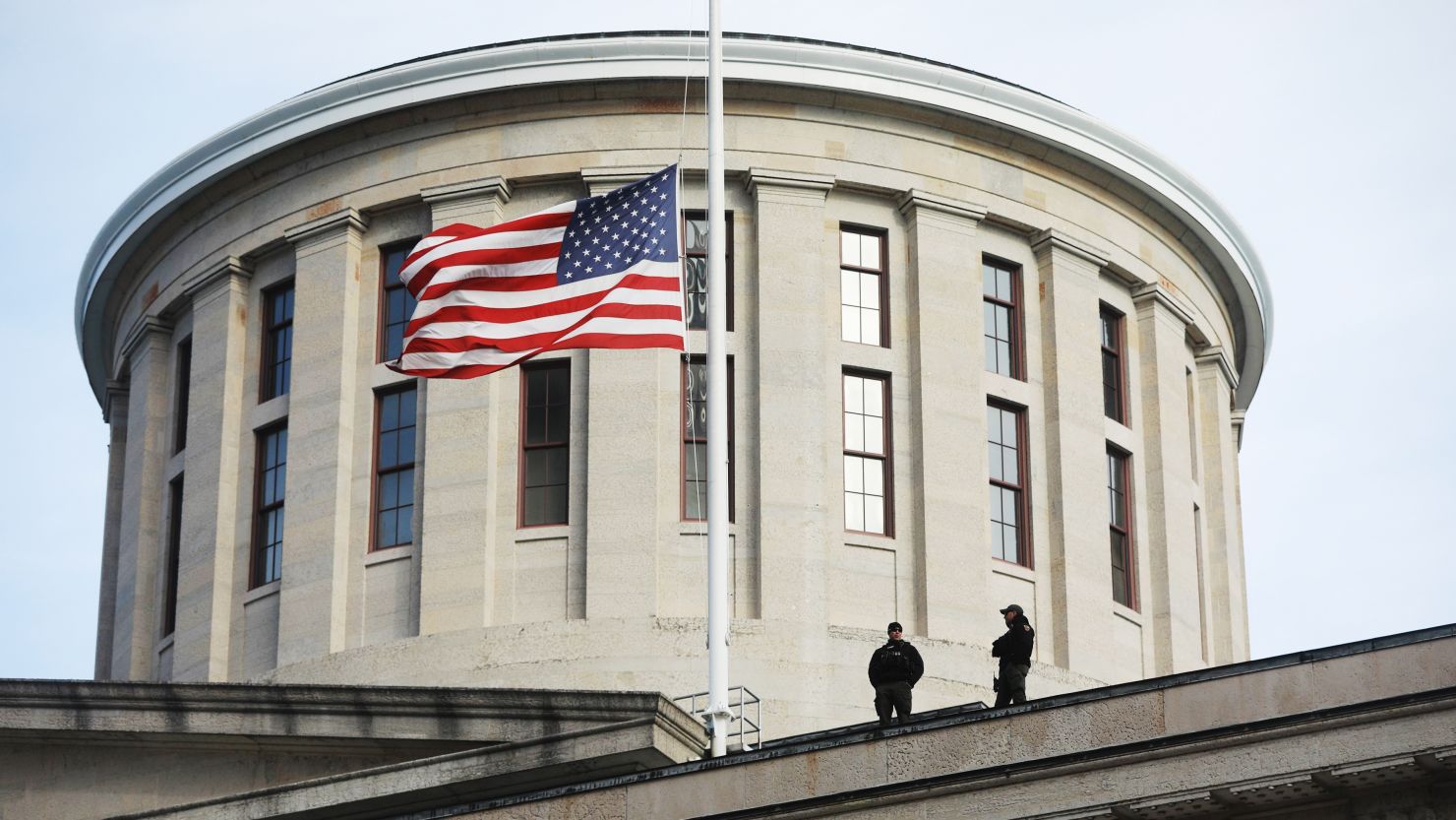 In this file photo from January 13, 2021, troopers are visible on the Ohio Statehouse roof in Columbus, Ohio.