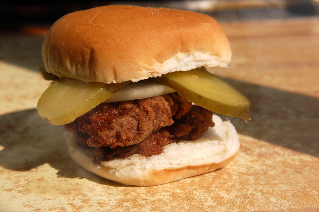Hamburger Wagon burger served with pickle, onion, salt and pepper.