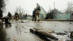 Ukrainian soldiers inspect the wreckage of a destroyed Russian armored column on the road in Bucha, a suburb north of Kyiv, on April 3.