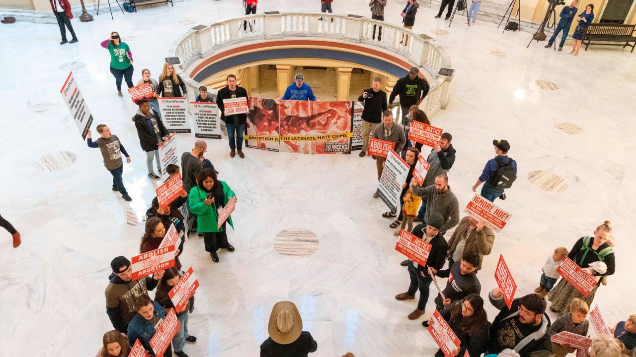 Anti-abortion activists stand outside the Oklahoma House chamber in Oklahoma City where Gov. Kevin Stitt delivers his State of the State address on February 7, 2022.