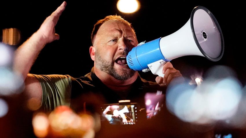 FILE — Infowars host and conspiracy theorist Alex Jones rallies pro-Trump supporters outside the Maricopa County Recorder's Office, Nov. 5, 2020, in Phoenix. Jones has agreed to appear at a deposition in Connecticut to answer questions in a lawsuit by relatives of some of the Sandy Hook Elementary School shooting victims, his lawyers said Thursday, March 31, 2022, a day after a judge ordered fines against Jones for defying orders to attend a deposition last week despite his claim of illness. (AP Photo/Matt York, File)