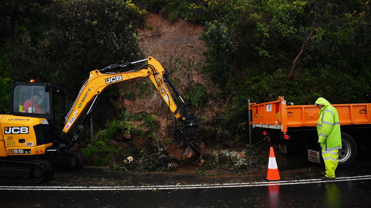 A landslide caused by torrential rain closes one lane of Lawrence Hargrave Drive at the Seacliff Bridge in Coalcliff, south of Sydney, Thursday. 