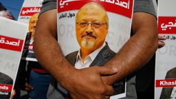 People hold posters of slain Saudi journalist Jamal Khashoggi, near the Saudi Arabia consulate in Istanbul, marking the two-year anniversary of his death, Friday, Oct. 2, 2020. The gathering was held outside the consulate building, starting at 1:14 p.m. (1014 GMT) marking the time Khashoggi walked into the building where he met his demise. The posters read in Arabic:' Khashoggi's Friends Around the World'. (AP Photo/Emrah Gurel)