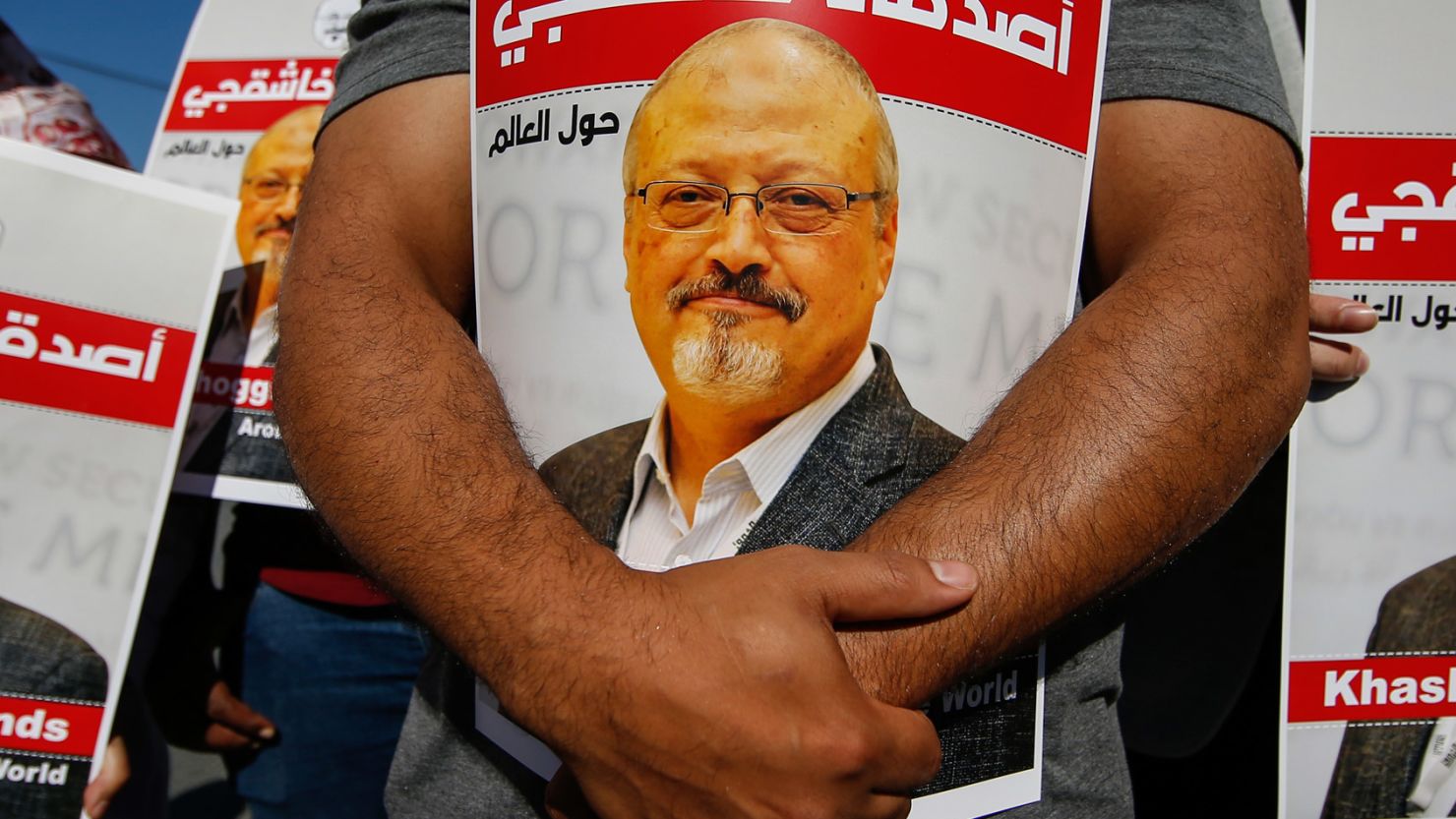 People hold posters of slain Saudi journalist Jamal Khashoggi near the Saudi Arabian consulate in Istanbul, marking the two-year anniversary of his death on Friday, October 2, 2020.