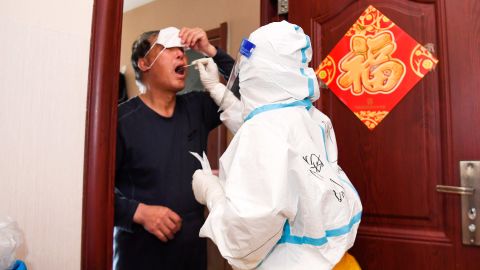 A medical worker carries out door-to-door testing in Changchun on April 5.