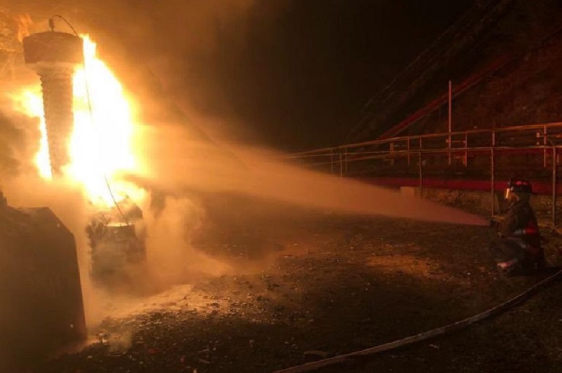 A firefighter battles flames at the Costa Sur power plant Wednesday.