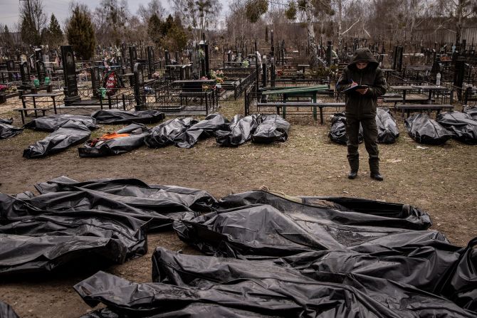 A man works to catalog some of the bodies of civilians who were killed in and around Bucha. <a href="index.php?page=&url=https%3A%2F%2Fwww.cnn.com%2F2022%2F04%2F03%2Feurope%2Fbucha-ukraine-civilian-deaths-intl%2Findex.html" target="_blank">Shocking images</a> showing the bodies of civilians scattered across the suburb of Kyiv sparked international outrage and raised the urgency of ongoing investigations into alleged Russian war crimes. Ukrainian President Volodymyr Zelensky called on Russian leaders to be held accountable for the actions of the nation's military. The Russian Ministry of Defense, without evidence, claimed the extensive footage of Bucha was "fake."
