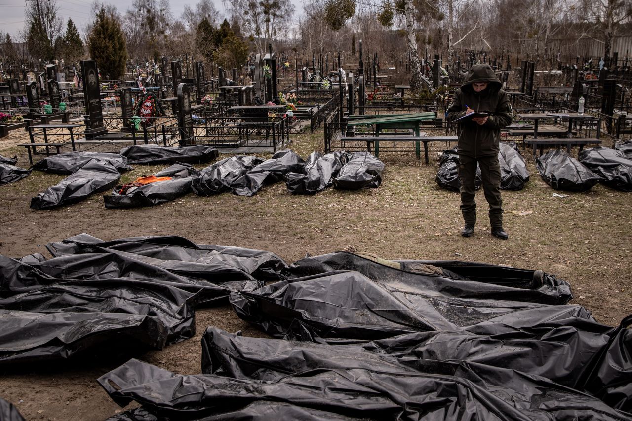 A man works to catalog some of the bodies of civilians who were killed in and around Bucha. <a target=