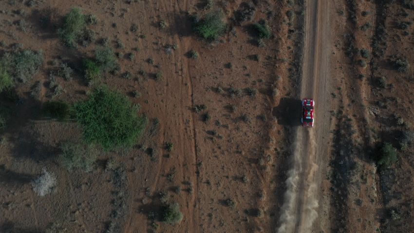 A classic rally car races across the Kenyan landscape