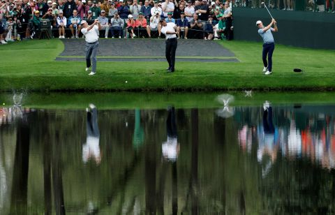 From left, Fred Couples, Woods and Thomas skip balls over the water at the 16th hole on Wednesday.  It's a practice round tradition at Augusta National.