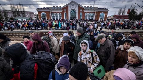Families walk on a platform to board a train at Kramatorsk central station as they flee the eastern city on April 5. 
