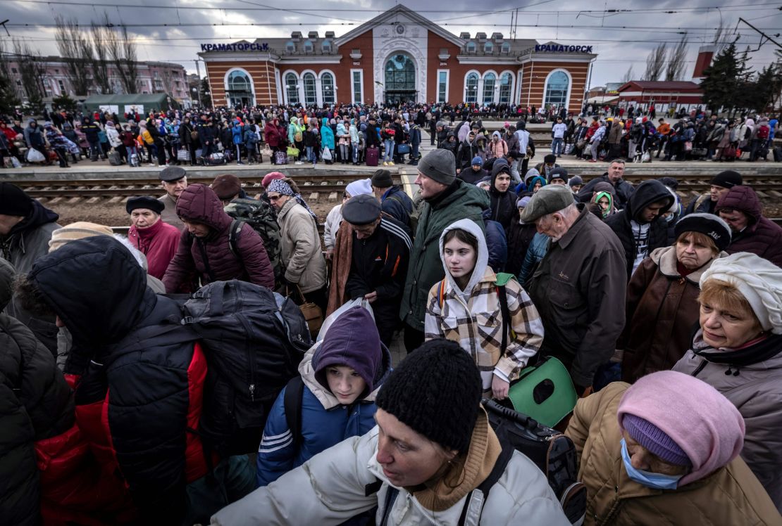Families walk on a platform to board a train at Kramatorsk central station as they flee the eastern city on April 5. 