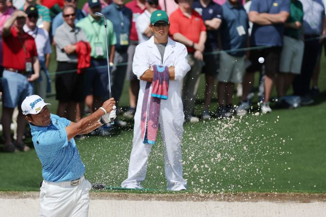 Defending champion Hideki Matsuyama plays a shot from a bunker on the second hole Thursday. <a href="index.php?page=&url=https%3A%2F%2Fwww.cnn.com%2F2021%2F04%2F08%2Fgolf%2Fgallery%2Fmasters-golf-2021%2Findex.html" target="_blank">When he won the green jacket last year,</a> Matsuyama became the first Japanese man to win any of the four major championships.