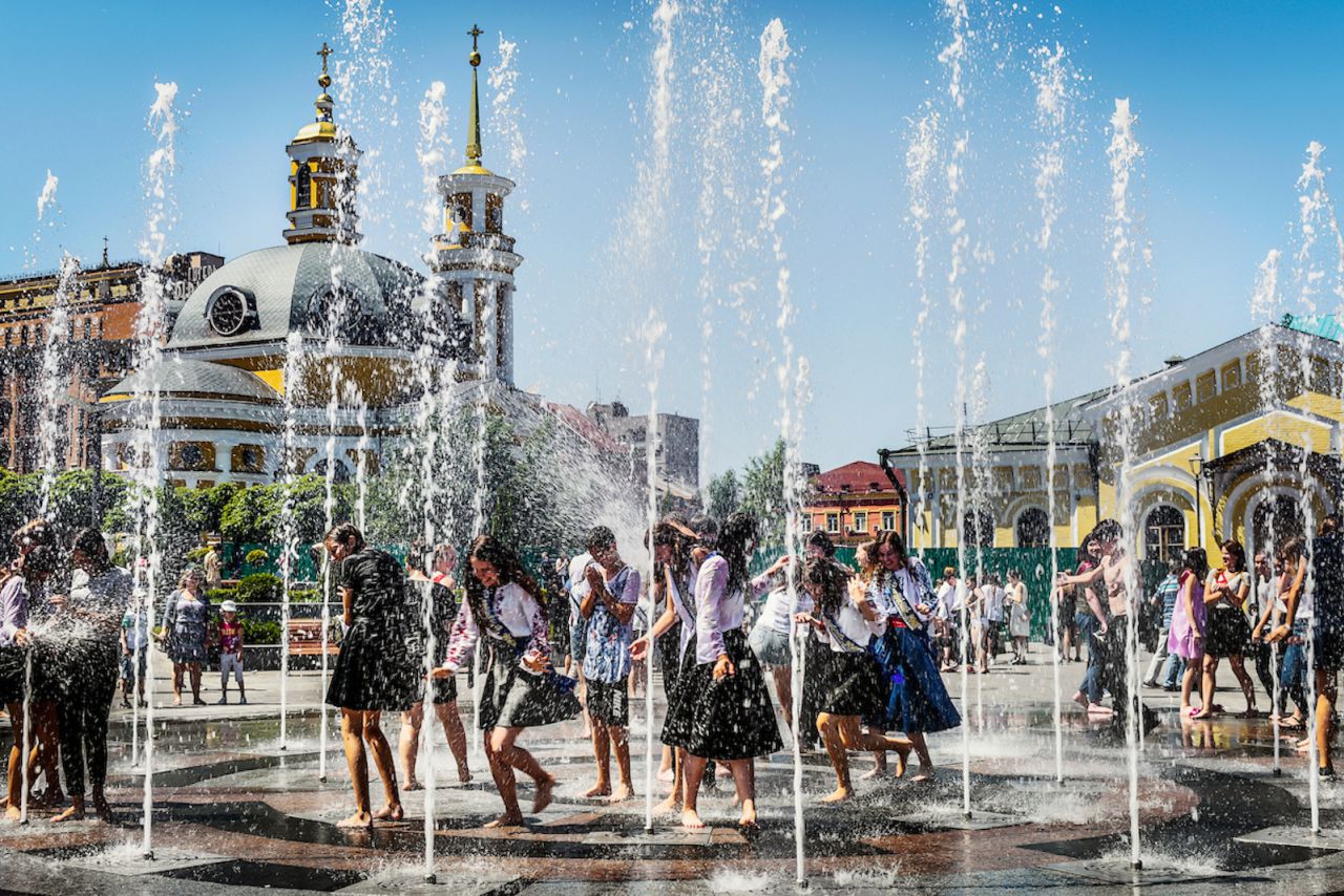 "Last Bell Kyiv" by Ukrainian-born photographer Dina Litovsky shows students hanging out at a fountain in Kyiv in May 2018.