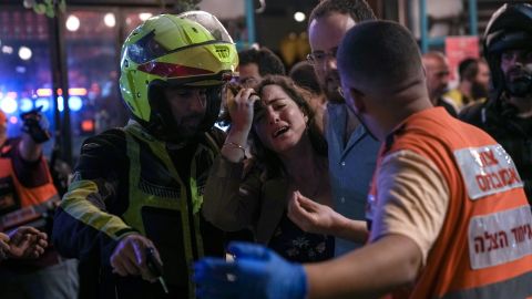 A woman reacts at the scene of a shooting in Tel Aviv on Thursday. 