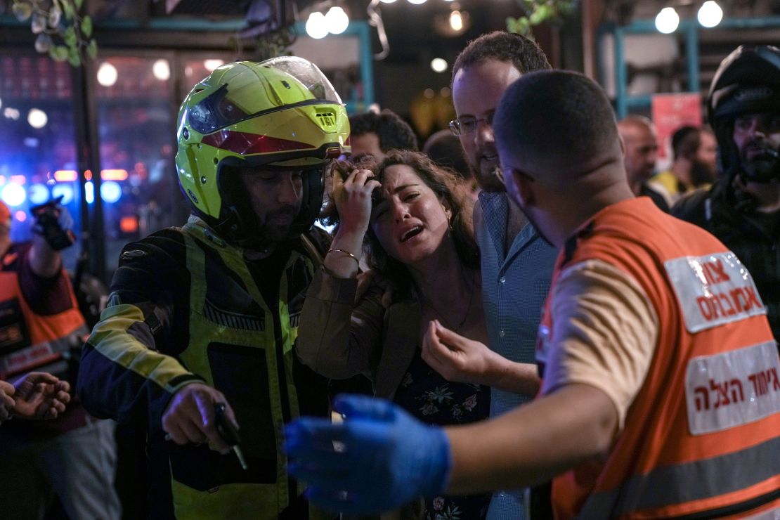 A woman reacts at the scene of a shooting in Tel Aviv on Thursday. 