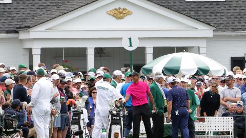 The group of Tiger Woods, Joaquin Niemann and Louis Oosthuizen meet at the first tee ahead of the first round of the Masters.