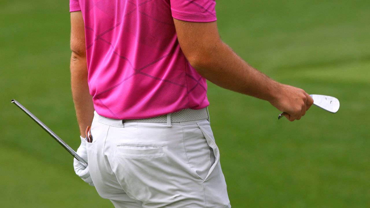 Wolff holds a broken club after breaking it after his tee shot on the fourth hole.