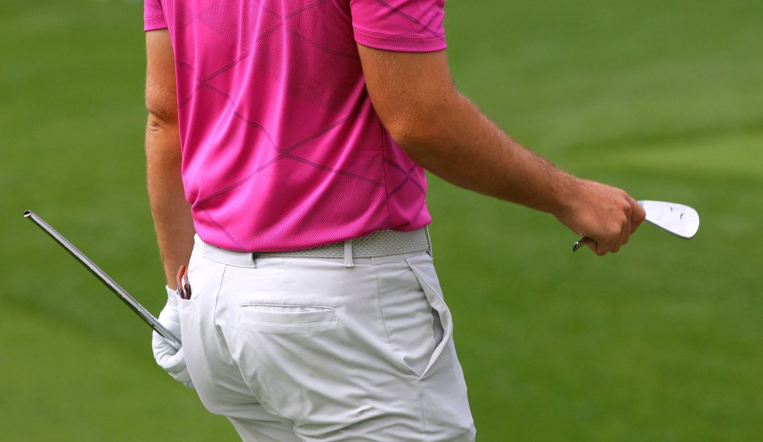 Wolff holds a broken club after breaking it after his tee shot on the fourth hole.