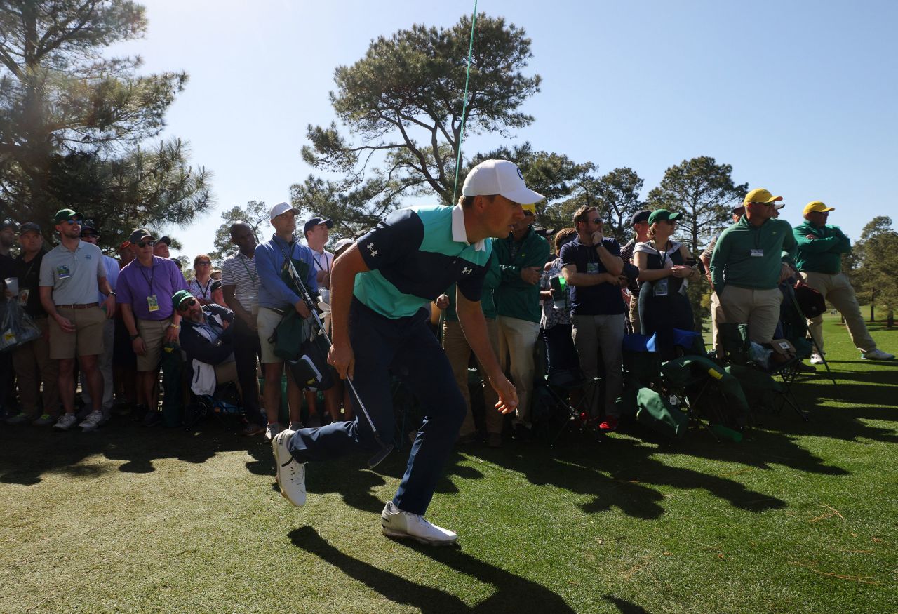 Jordan Spieth, who won the Masters in 2015, ducks under a rope after playing a shot on the seventh hole Thursday.