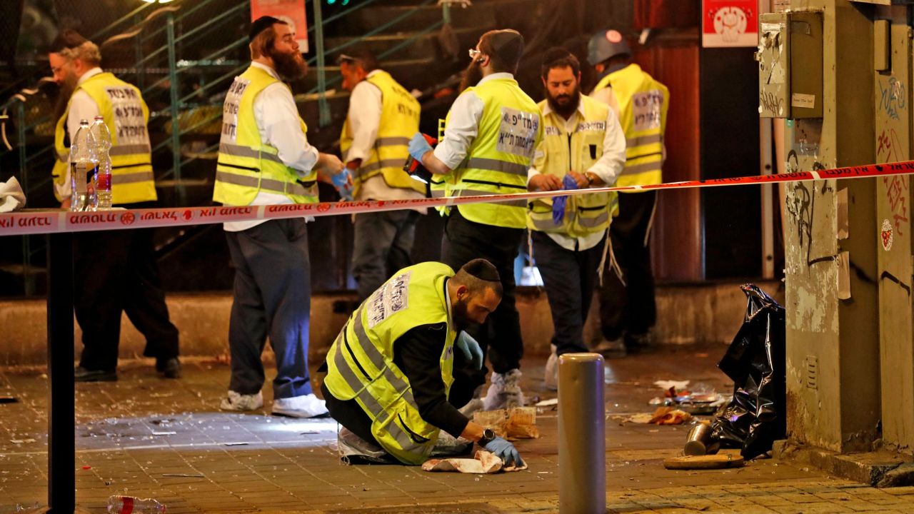 Forensics experts investigate the scene of a shooting in Tel Aviv, Israel, on Thursday.
